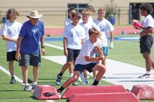 (ALEX HAVARDANSKY | THE GRAHAM LEADER) Steers football campers work on cutting upfield as a runningback Wednesday, July 30. Steers head coach Clay McChristian said that the older kids session focused on specific assigned positions based on player strengths. 