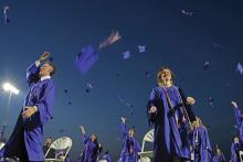 (THOMAS WALLNER | THE GRAHAM LEADER) The Graham High School Class of 2023 tosses their graduation caps into the air Friday, May 26 at Newton Field as they move into the next chapter of their lives. The graduates were given speeches by the top three students in the class: Nolan Casbeer, Claire Mairena and Jennifer Martinez-Garcia.