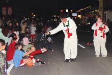 (THOMAS WALLNER | THE GRAHAM LEADER) Children at the 2023 lighted Christmas parade look to snag a treat from a parade entry walking around the downtown square. The parade will be held Thursday, Dec. 5.