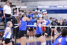 (TC GORDON | THE GRAHAM LEADER) Senior Olga Morales (12) hits a ball back over the net while her teammates look on during Graham’s area round playoff game against Decatur. The Lady Blues lost in three sets which ended their season.