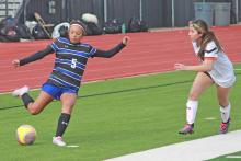 (TC GORDON | THE GRAHAM LEADER) Sophomore Mai Bara (5) crosses a pass to one of her teammates during one of Graham’s games at the Gainesville tournament over the weekend. The Lady Blues took 2nd place overall and finished with a 3-1 record.