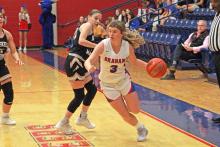 (TC GORDON | THE GRAHAM LEADER) Mayci Ryans drives past Haskell defenders on the offensive side of the ball during Graham’s season-opening loss to Haskell Tuesday, Nov. 7. The Lady Blues fought hard in the second half but lost 41-20.