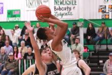 (TC GORDON | THE GRAHAM LEADER) Newcastle’s Jacob Omundi gets fouled while making a layup during the team’s district-opening loss Tuesday, Dec. 19 to the Graford Rabbits. The Bobcats fought hard but lost 80-51.