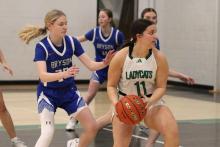 (ALEX HAVARDANSKY | THE GRAHAM LEADER) Emma Hawkins looks to pass the ball Tuesday, Feb. 3 against the Bryson Cowgirls. Hawkins was a pivotal player who helped Newcastle’s offense take control early in their 49-28 win. 