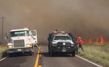 (THOMAS WALLNER | THE GRAHAM LEADER) A Young County Precinct 4 water truck and an Eliasville VFD truck spring into action following a grassfire on FM 209 jumping the road Sunday, Sept. 21. 