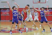 (LIAM BAILEY | THE GRAHAM LEADER) Ty Thompson jumps to throw the ball to an open teammate while Brock defenders jump to stop him Tuesday, Jan. 28. Thompson was the top scorer for the Steers during the game. 