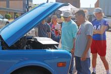 (ARCHIVE PHOTO | THE GRAHAM LEADER) A group gathers around a vehicle shown off at the 12th annual Cars and Stars car show on the Graham downtown square. The event was canceled last year, but will be returning to the square from 10 a.m. to 2 p.m. Saturday, Oct. 12.