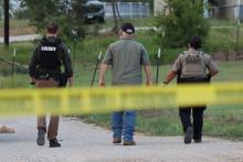 (THOMAS WALLNER | THE GRAHAM LEADER) Young County Sheriff Travis Babcock walks down High Street in Newcastle where a shooting occurred Sunday, Aug. 17.