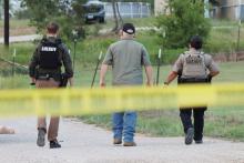 (THOMAS WALLNER | THE GRAHAM LEADER) Young County Sheriff Travis Babcock (center) walks down High Street in Newcastle with deputies where a shooting occurred Sunday, Aug. 17.