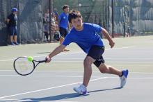(ALEX HAVARDANSKY | THE GRAHAM LEADER) Brodey Mills gets low to get after a ball Saturday, Aug. 2. Mills flipped the switch in his second mixed doubles match to help pull out a dominant 8-4 win. 