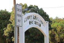 (THOMAS WALLNER | THE GRAHAM LEADER) The entranceway to the Oak Grove Colored - William P. Johnston Cemetery along with a sign showing parking at the cemetery. 