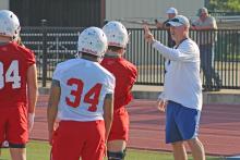 (ALEX HAVARDANSKY | THE GRAHAM LEADER) Steers head coach Clay McChristian instructing his players at two-a-day practices Tuesday, Aug. 5. McChristian said the first couple of practices for the Steers are all about refreshing on the basics.