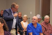 (THOMAS WALLNER | THE GRAHAM LEADER) Graham City Manager Eric Garretty answers a question from Graham resident Greg Bonzelaar during a town hall meeting Tuesday, Aug. 26. Members of the public spoke at the meeting Tuesday and voiced concerns regarding a number of city topics.