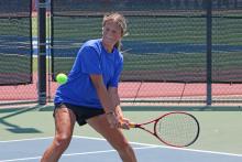 (ALEX HAVARDANSKY | THE GRAHAM LEADER) Kline Krupp makes a two-handed swing on a ball Wednesday, Aug. 6, against Stephenville. Krupp was one of four Lady Blues who picked up a singles victory. 