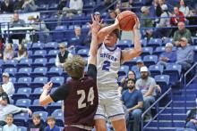 (THOMAS WALLNER | THE GRAHAM LEADER) Bryce Martin of the Steers jumps over a Brownwood defender to make a shot near the net during the game Friday, Jan. 31. Both teams brought their all during the matchup but Graham came out on top.