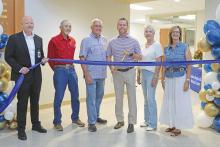(THOMAS WALLNER | THE GRAHAM LEADER) Graham Regional Medical Center CEO Shane Kernell and member of the GRMC Board of Directors cut the ribbon for the new wing of the hospital during a grand opening ceremony held Wednesday, May 14. Shown from left to right are Kernell, Jon Garvey, Terry Bishop, Wyatt Pettus, Sylvia Overton and Suzy Graham.