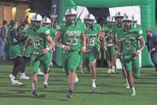 (ARCHIVE PHOTO | THE GRAHAM LEADER) The Newcastle Bobcats march onto the field Friday, Nov. 22, 2024, against Westbrook in their area playoff matchup. The Bobcats football team along with several other Newcastle fall athletic teams will be presented at the meet the Bobcats booster bash event.