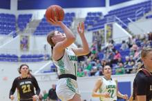 (THOMAS WALLNER | THE GRAHAM LEADER) Camren Mallory lines up a shot past the Lady Longhorns defense during the bi-district matchup Monday, Feb. 10. The Newcastle team won 56-31 over Forestburg during the game at Wichita Falls.