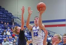 (THOMAS WALLNER | THE GRAHAM LEADER) Cooper Wilde jumps to make a shot for the Steers near the net Tuesday, Feb. 11. Graham struggled to break the defense of the Stephenville Yellow Jackets and fell 50-35 in their last district game.