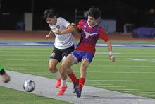 (KYLIE BAILEY | THE GRAHAM LEADER) Sergi Unanue fights for the ball during the matchup Friday, Feb. 7 against Burkburnett. The Steers came away with a big 5-1 victory over the Bulldogs in their second district game on their schedule.