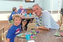(VIRGINIAS HOUSE | CONTRIBUTED PHOTO) Mentor Glenn McGee meets with his mentee during a mentor event held by Virginia's House in Graham. The mentor program has grown in volunteers recently.