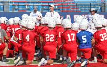 (ARCHIVE PHOTO | THE GRAHAM LEADER) Graham head coach Clay McChristian (standing center) speaks to the team at the end of one of their practices during the first week of fall camp last season. 