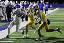 (ALEX HAVARDANSKY | THE GRAHAM LEADER) Colt Taylor runs the ball to the sideline while stiff arming defenders Friday, Oct. 31 against the Brock Eagles. Taylor and Dylan Cox were the primary runners in the backfield in the Steers loss to Brock.