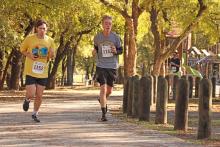 (THOMAS WALLNER | THE GRAHAM LEADER) Two runners in the 2024 Spivey Hill Challenge round the corner near the Firemen’s Park playground. Trails at the park will be expanded soon.
