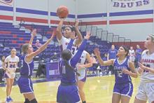 (TC GORDON | THE GRAHAM LEADER) Rebecca McGregor shoots a contested mid-range shot over the outstretched arms of multiple Stamford defenders Tuesday, Nov. 19 during Graham’s 45-35 win.