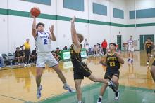 (TC GORDON | THE GRAHAM LEADER) Steers sophomore Bryce Marin leans back to set up a shot over Snyder players during the Breckenridge tournament held from Thursday, Dec. 5 through Saturday, Dec. 7. 