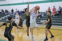 (ARCHIVE PHOTO | THE GRAHAM LEADER) Tyler Allen of the Steers races past defenders to set up a shot during a tournament earlier in the season. The Steers matched up against the Henrietta Bearcats, but came up short in a 50-43 loss Tuesday, Dec. 10.  