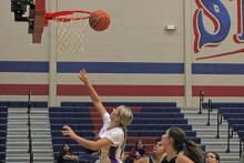 (ALEX HAVARDANKSY | THE GRAHAM LEADER) Ava Street lays the ball up under the basket during the Lady Blues season opener. Street hit a two point jumper in the Lady Blues’ win Tuesday, Nov. 18 against the Windthorst Trojanettes. 