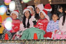 (THOMAS WALLNER | THE GRAHAM LEADER) Children laugh from a float in the 2024 lighted parade from the Graham Chamber of Commerce. The parade is right around the corner along with the stroll and Hot Chocolicious competition.
