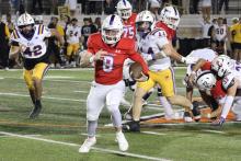 (ALEX HAVARDANSKY | THE GRAHAM LEADER) Jace Gill runs out of the pocket to the sideline Friday, Nov. 14 against the Godley Wildcats. Gill was very effective extending drives with his legs leading to multiple scores in the game.
