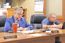 (TC GORDON | THE GRAHAM LEADER) Young County Judge Win Graham (left) reads a statement about the budget process before the start of public hearings for the 2024-2025 fiscal year tax rate and budget. Following the hearings Monday, Aug. 26, the county commissioners voted to adopt the tax rate and budget.