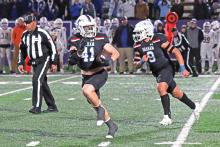 (ARCHIVE PHOTO | THE GRAHAM LEADER) Linebacker Jayton Hearne (41) checks over his shoulder as he begins to return an interception he caught while teammate Mateo Rodriguez (9) to block.