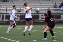 (KYLIE BAILEY | THE GRAHAM LEADER) Calen Dawson jumps up to black the ball Friday, Feb. 20 against the Bridgeport Lady Bulls. The defense was once again stellar for the Lady Blues in their fourth shutout in district play out of five games played. 