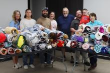 (THOMAS WALLNER | THE GRAHAM LEADER) Volunteers pose for a group photo after wrapping 153 bundles of blankets, stuffed animals and goody bags which will be delivered to Young County first responders. The bundles will be used when county first responders respond to a situation with a child in crisis.