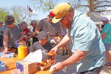 (ARCHIVE PHOTO | THE GRAHAM LEADER) Visitors to the Crawfish and Cannons event in 2024 season up their crawfish at a table within Fort Belknap. The event will be back at the fort Saturday, April 12 with cannon fire, music and more.