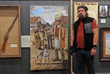 (THOMAS WALLNER | THE GRAHAM LEADER) Artist Marc Nesbitt stands next to his portrait at the Young County Museum of History and Culture for their exhibit showcasing the life of Britt Johnson. The portrait is a permanent addition to the local museum.