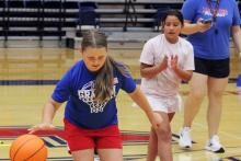 (ALEX HAVARDANSKY | THE GRAHAM LEADER) A Lady Blues camper practices dribbling on an obstacle course during Lady Blues basketball camp Tuesday, June 3. Teammates were also encouraged to cheer their Lady Blues teammates on.