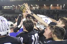 (ALEX HAVARDANSKY | THE GRAHAM LEADER) The Steers celebrate with their area championship trophy Friday, Nov. 21. Several members of the Steers were selected for all-district awards to honor their excellence as athletes as well as students. 