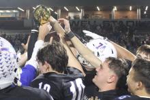 (ALEX HAVARDANKSY | THE GRAHAM LEADER) The Steers celebrate with their area championship trophy Friday, Nov. 21 after defeating the Lubbock-Cooper Liberty Patriots 35-28. Head coach Clay McChristian said he was proud of the team’s fight against a tough opponent. 