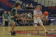 (ALEX HAVARDANKSY | THE GRAHAM LEADER) Tyler Allen looks to pass the ball Monday, Nov. 24 against the Breckenridge Buckaroos. Allen scored four points in the Steers 48-44 win over the Buckaroos.
