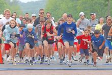 (ARCHIVE PHOTO | THE GRAHAM LEADER) Participants in the 5K race for the 2024 Run for the Children event take off from the starting point at Third Street and Oak Street. The event this year will be taking off at the same location Saturday, April 26.