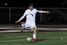 (KYLIE BAILEY | THE GRAHAM LEADER) Nolan Wankowicz winds up to kick a ball into the field of play Friday, Feb. 20 against Bridgeport. The Steers fought hard but lost to the Bulls 5-1. 