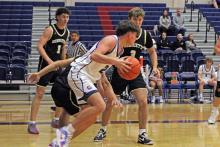 (ALEX HAVARDANSKY | THE GRAHAM LEADER) Bryce Martin dribbles the ball outside of the paint Tuesday, Dec. 9 against Henrietta. Martin scored five points in the Steers’ 63-39 loss to the Bearcats.