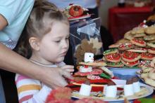 (THOMAS WALLNER | THE GRAHAM LEADER) A visitor to Cookie Day in December 2024 stacks a plate of cookies. The holiday tradition will be returning Friday, Dec. 12 in Graham.