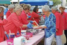(ARCHIVE PHOTO | THE GRAHAM LEADER) Members of the Graham Regional Medical Center Auxiliary prepare meals for the annual Chalupa Luncheon in 2024. The event will be moving this year from the Young County Courthouse lawn to nearby the Graham Chamber of Commerce. 