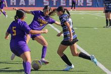 (ALEX HAVARDANSKY | THE GRAHAM LEADER) Brianna Hernandez tries to break away from defenders Friday, Dec. 12 against the Sanger Lady Indians. The Lady Blues’ offense surged in their first scrimmage match, winning by a final score of 8-0. 